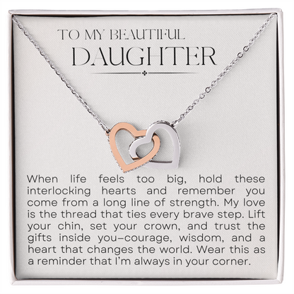 Close-up of Interlocking Hearts necklace on heartfelt message card for daughter
