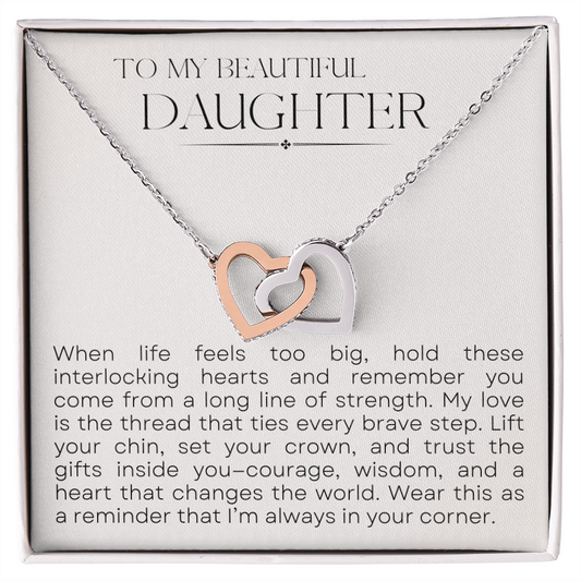 Close-up of Interlocking Hearts necklace on heartfelt message card for daughter